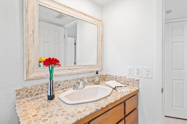 bathroom with vanity and a textured ceiling