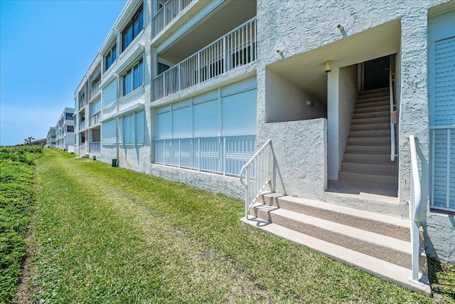 exterior space with a yard and a balcony