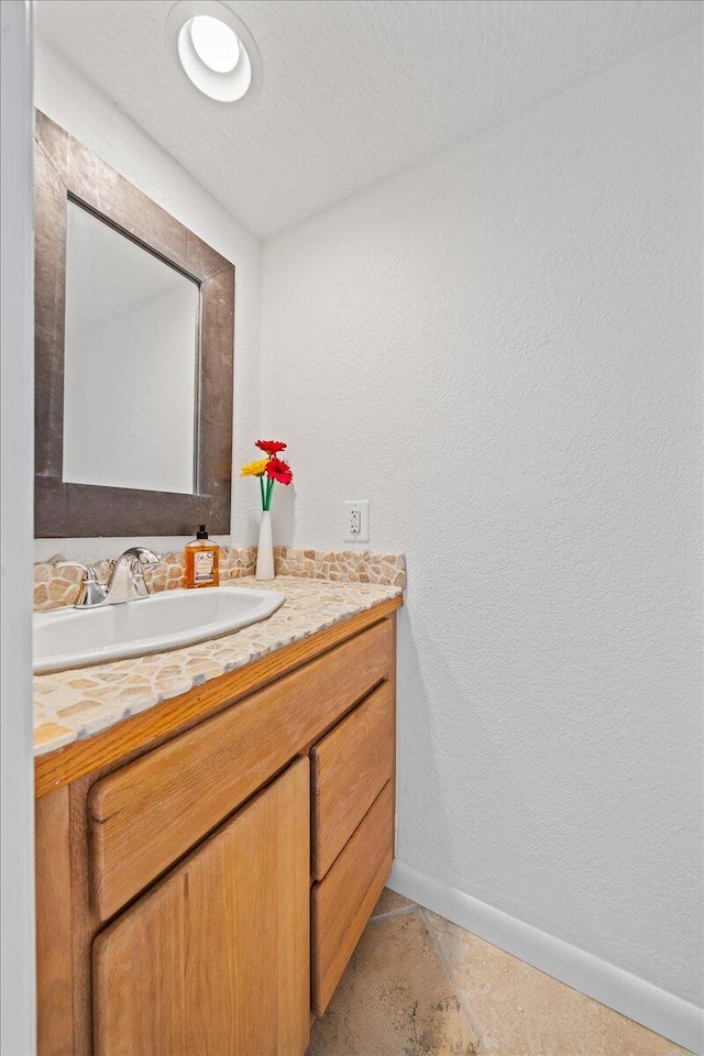 bathroom featuring tile flooring and vanity