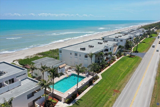 birds eye view of property with a view of the beach and a water view