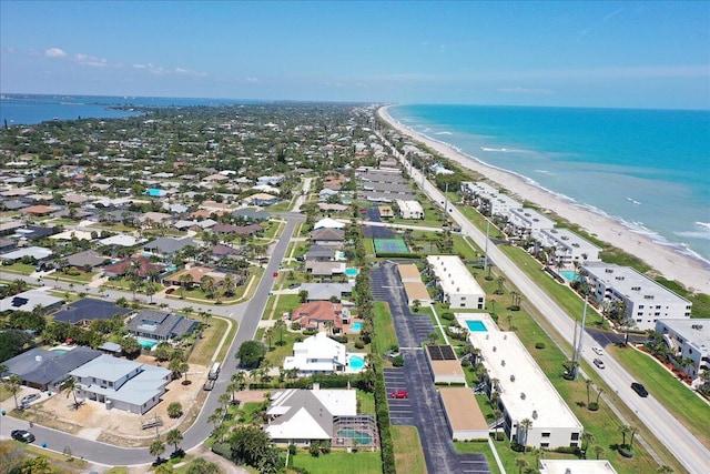 birds eye view of property with a beach view and a water view