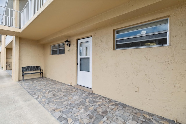 entrance to property with a patio and a balcony