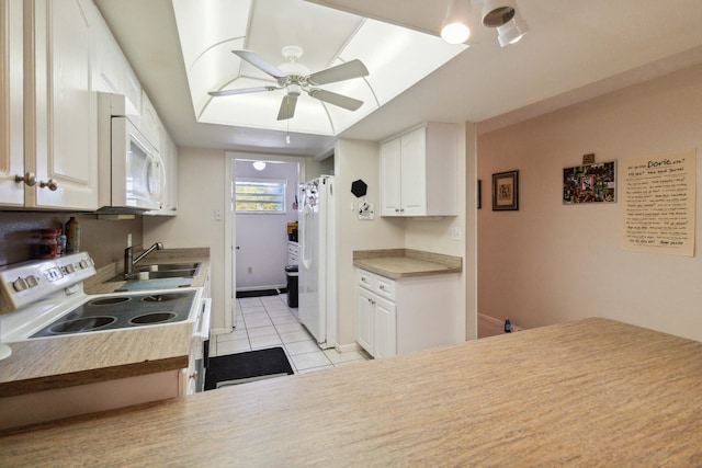 kitchen featuring white appliances, light tile flooring, white cabinetry, sink, and ceiling fan