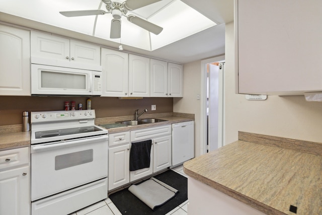 kitchen featuring white appliances, ceiling fan, white cabinetry, sink, and light tile floors