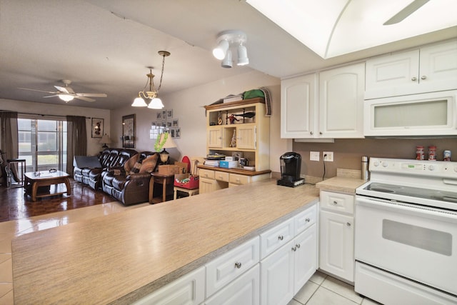 kitchen with hanging light fixtures, white appliances, ceiling fan, white cabinetry, and light tile floors