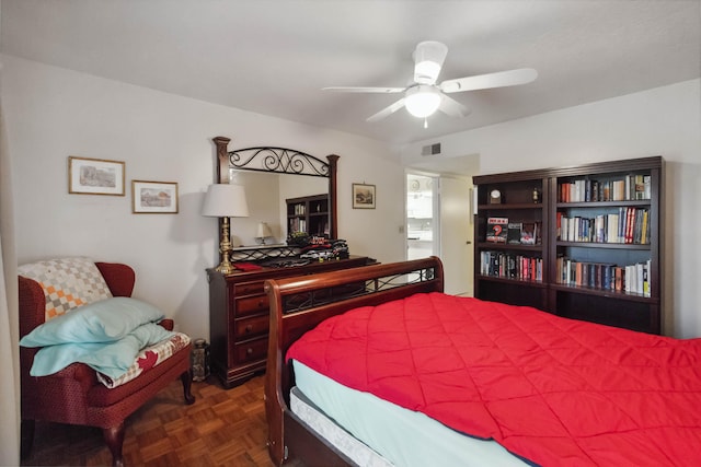 bedroom with dark parquet floors and ceiling fan