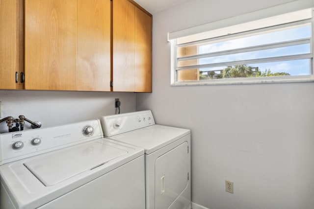 laundry area with cabinets and independent washer and dryer