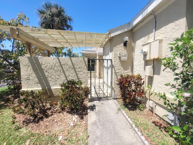 doorway to property with a pergola