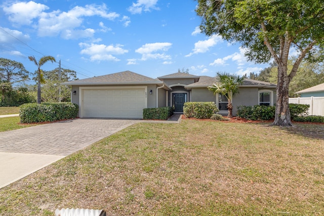 single story home with a garage and a front lawn