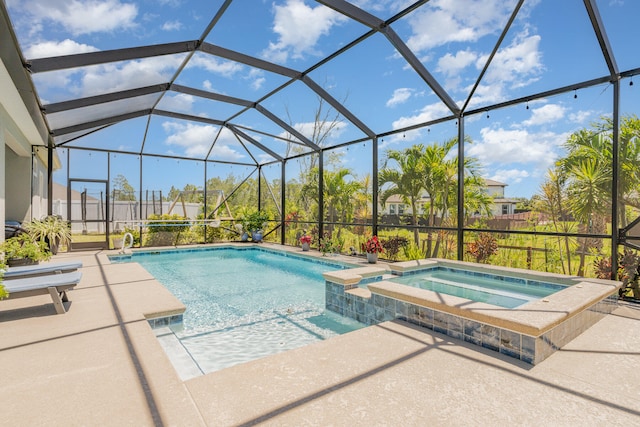 view of pool with a patio area, a lanai, and an in ground hot tub