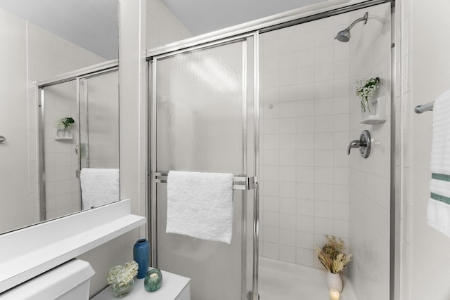 bathroom featuring toilet and an enclosed shower