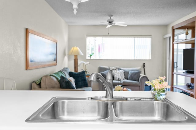 interior space featuring ceiling fan, a textured ceiling, and sink