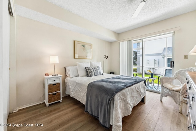 bedroom featuring a textured ceiling, ceiling fan, and hardwood / wood-style flooring