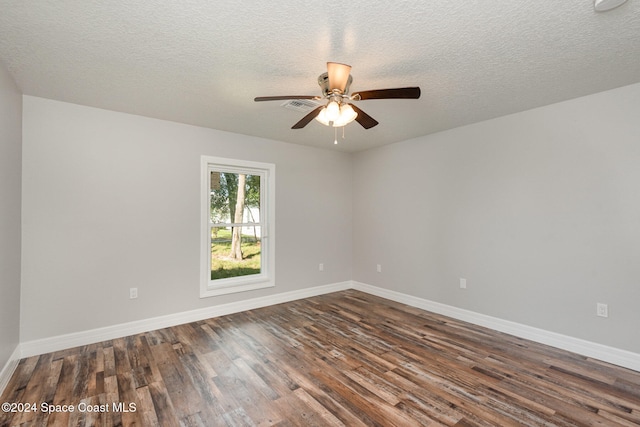 spare room featuring a textured ceiling, dark hardwood / wood-style floors, and ceiling fan