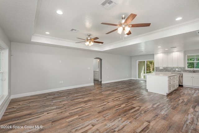 kitchen with dark hardwood / wood-style flooring, white cabinetry, and crown molding