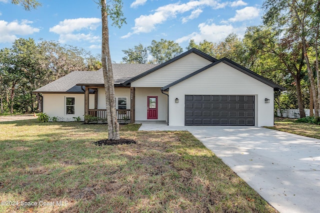 view of front of property with a front lawn, a porch, and a garage