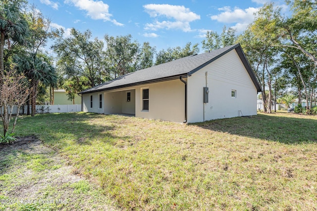 back of house with a lawn