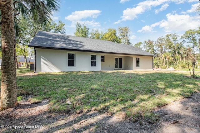 back of house with a yard