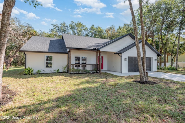 single story home featuring a porch, a garage, and a front lawn