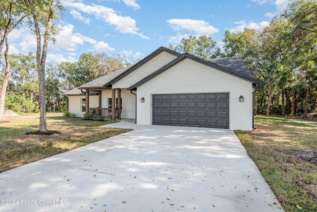 view of front of house with a garage and a front lawn