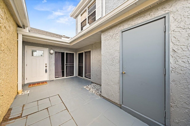 entrance to property featuring a patio