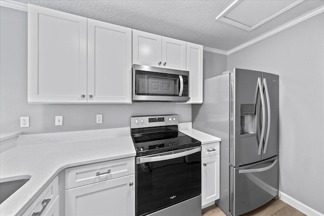 kitchen featuring light hardwood / wood-style flooring, stainless steel appliances, light stone counters, and white cabinetry