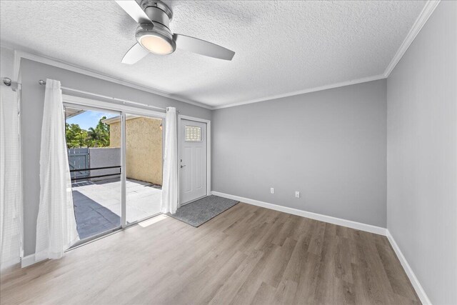 spare room with light hardwood / wood-style floors, ceiling fan, and a textured ceiling