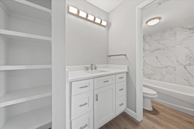 full bathroom with wood-type flooring, vanity, toilet, and tiled shower / bath