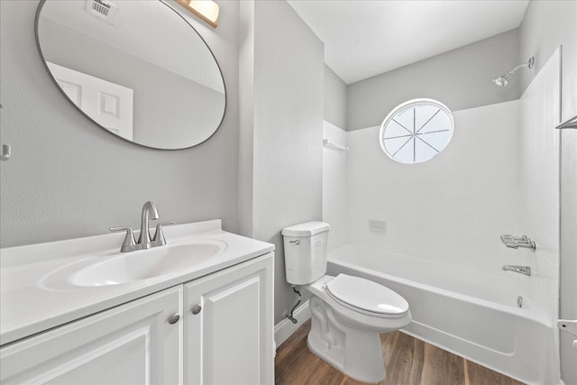 full bathroom featuring vanity with extensive cabinet space, shower / tub combination, toilet, and hardwood / wood-style flooring