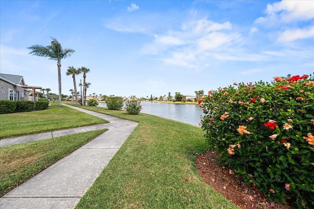 exterior space with a water view and a lawn