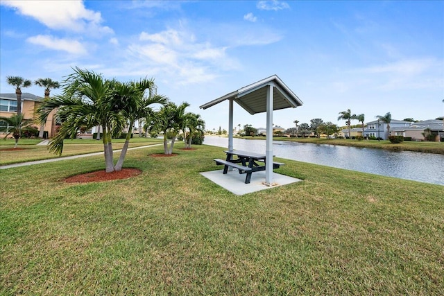 view of property's community featuring a yard and a water view