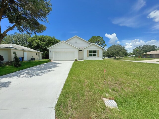 single story home with a garage and a front yard