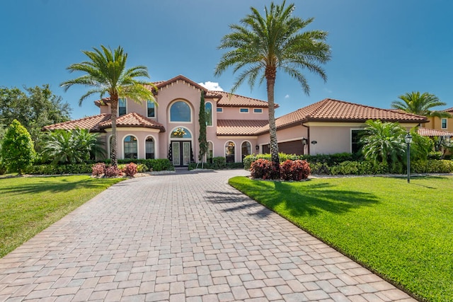 mediterranean / spanish house with a front yard