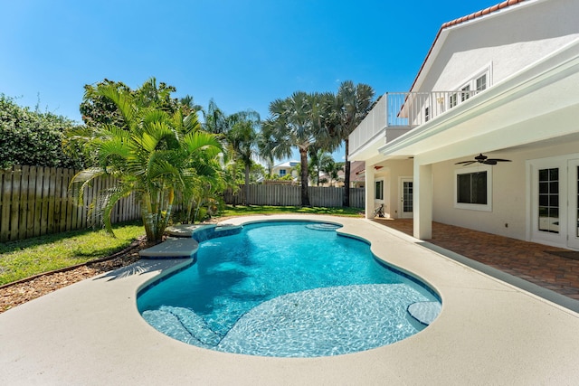 view of swimming pool featuring ceiling fan and a patio