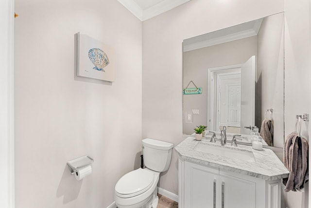 bathroom featuring vanity, ornamental molding, and toilet