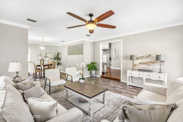 living room featuring ceiling fan, wood-type flooring, and ornamental molding