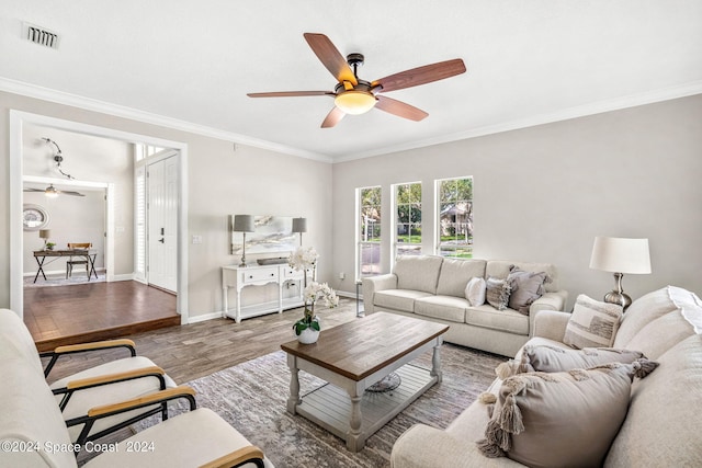 living room featuring light wood-type flooring and crown molding