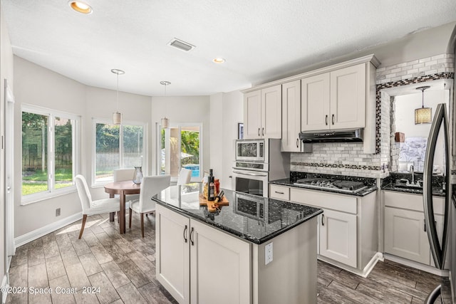 kitchen featuring white cabinetry, plenty of natural light, and appliances with stainless steel finishes