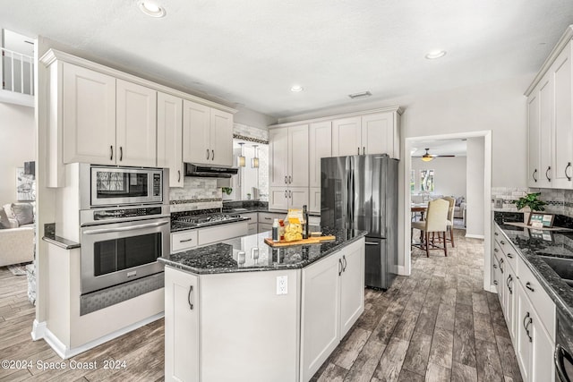 kitchen with dark hardwood / wood-style flooring, white cabinetry, and appliances with stainless steel finishes