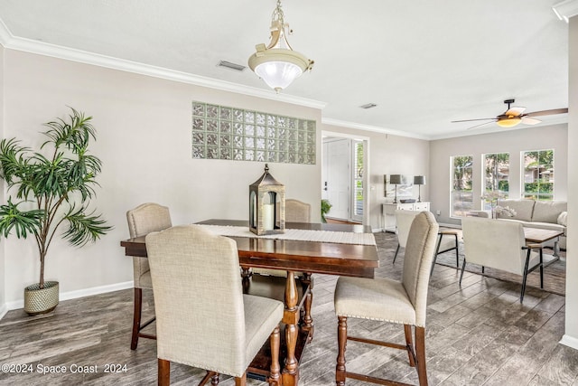 dining area featuring ceiling fan, dark hardwood / wood-style floors, and ornamental molding