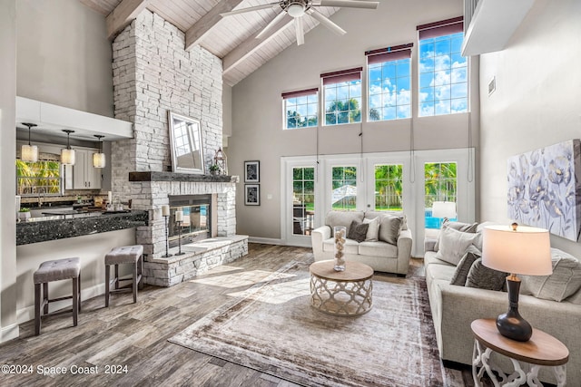 living room featuring hardwood / wood-style flooring, ceiling fan, wooden ceiling, and high vaulted ceiling