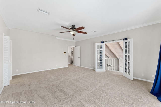 carpeted empty room with ceiling fan and ornamental molding