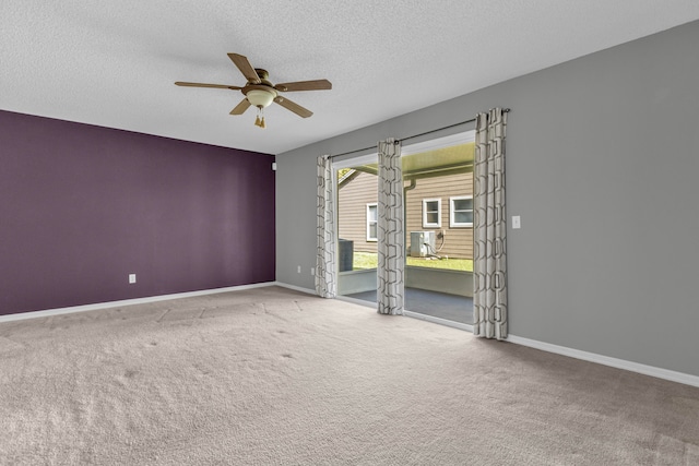 unfurnished room with carpet, ceiling fan, a textured ceiling, and baseboards