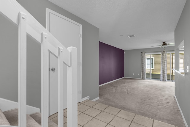 tiled empty room with ceiling fan