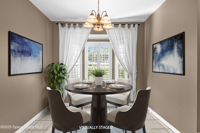 dining room featuring baseboards, light tile patterned flooring, and a notable chandelier