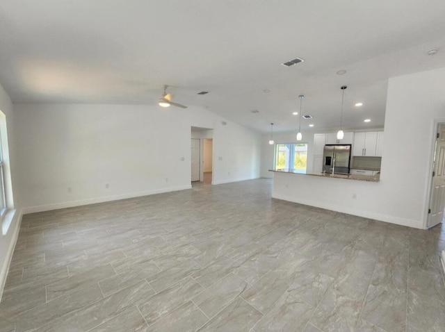 unfurnished living room with vaulted ceiling, ceiling fan, and light tile floors