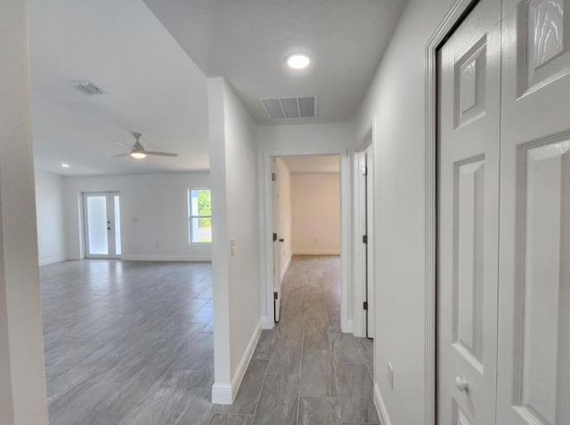 hallway with hardwood / wood-style floors