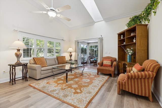 living room with high vaulted ceiling, ceiling fan, light hardwood / wood-style floors, and crown molding