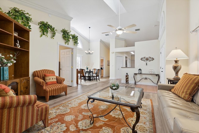 living room with high vaulted ceiling, light hardwood / wood-style flooring, ceiling fan with notable chandelier, and ornamental molding