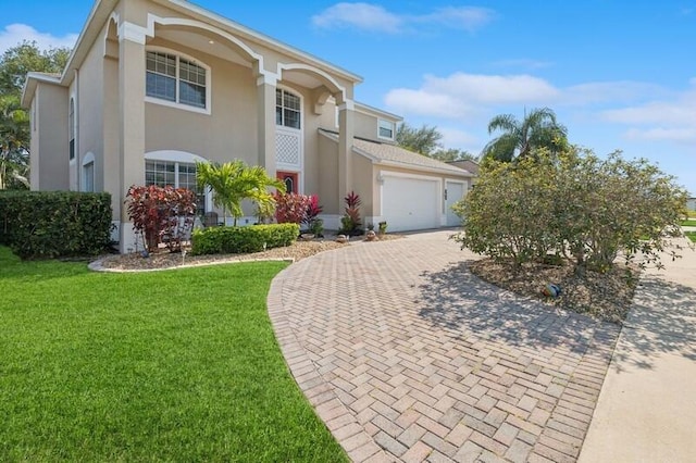 view of front of property featuring a garage and a front lawn